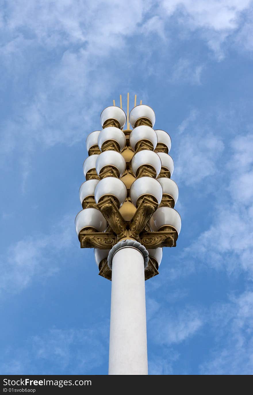 Lamp post on background sky, golden candelabrums