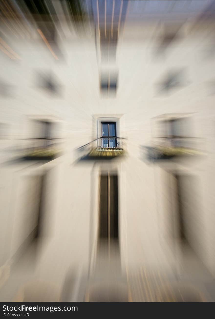 Window with french balcony on a blurred wall