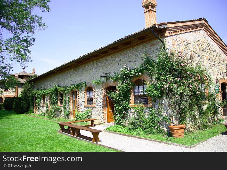 Outside of a house in stones with climbing plants