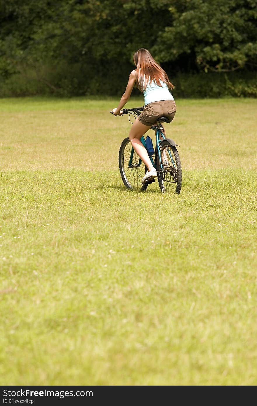 Active woman sat on a bike outdoors. Active woman sat on a bike outdoors