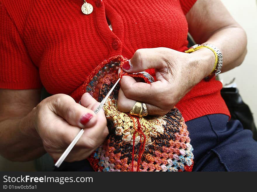 Senior woman's hands knitting a scarf