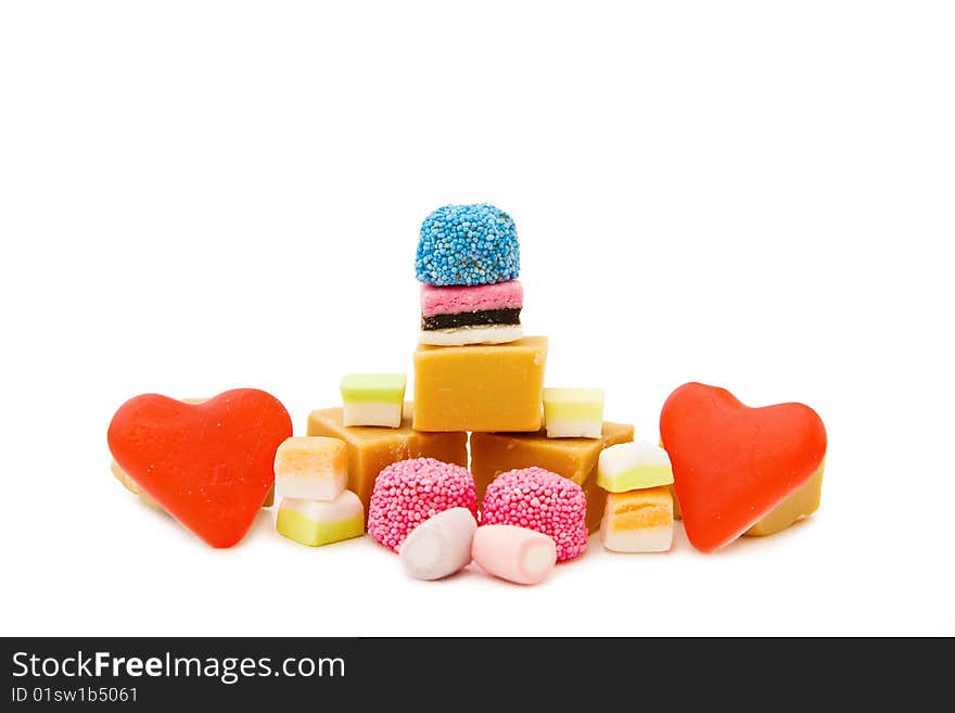 Sweets heaven - mix of caramel fudge, jelly hearts, marshmallow and colorful candy isolated on white. This image is exclusive to DT. Sweets heaven - mix of caramel fudge, jelly hearts, marshmallow and colorful candy isolated on white. This image is exclusive to DT.