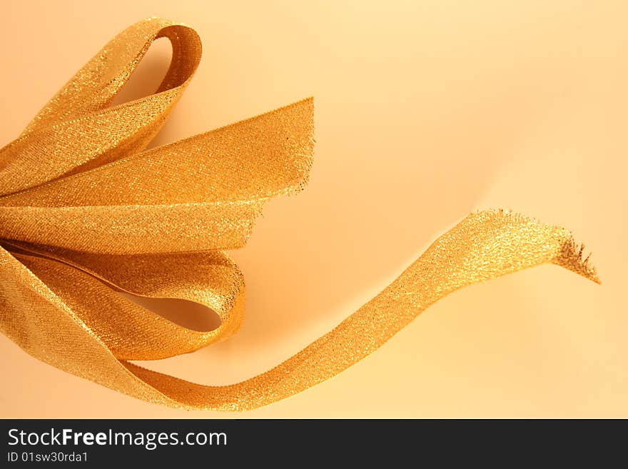 Half of a golden christmas ribbon. Half of a golden christmas ribbon.