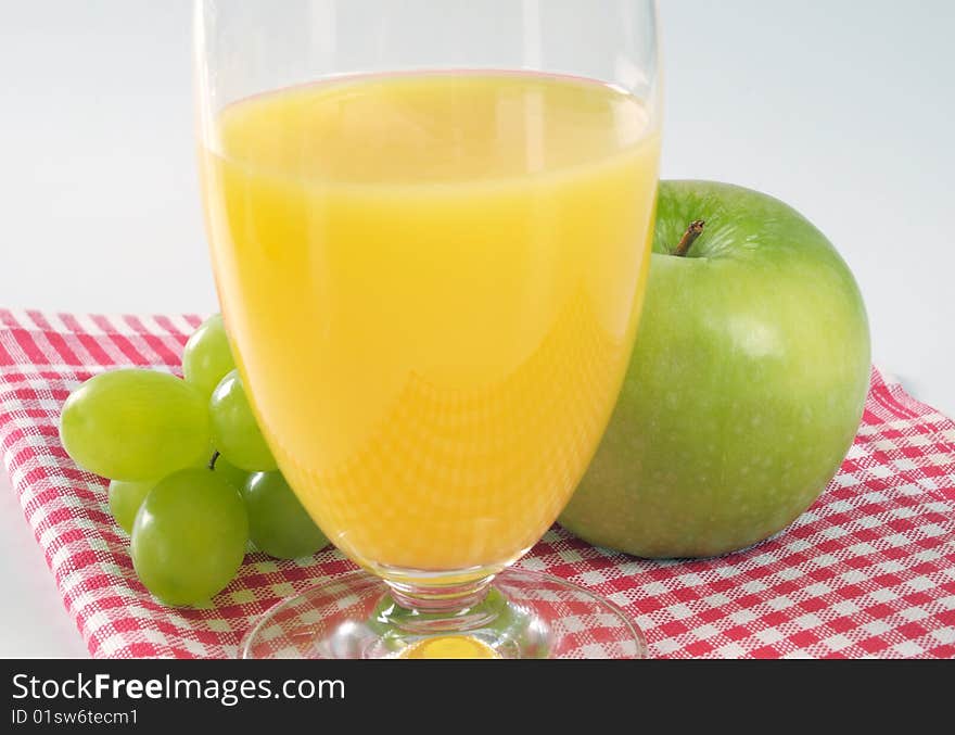 Glass of orange juice and green apple. Glass of orange juice and green apple