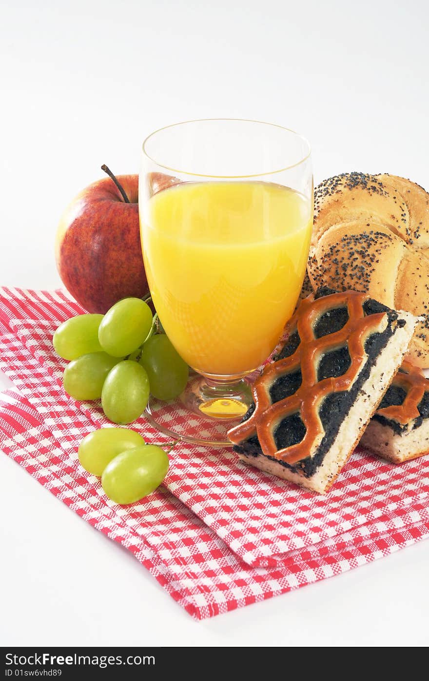 Still life of a glass of juice, pastry and fruit. Still life of a glass of juice, pastry and fruit