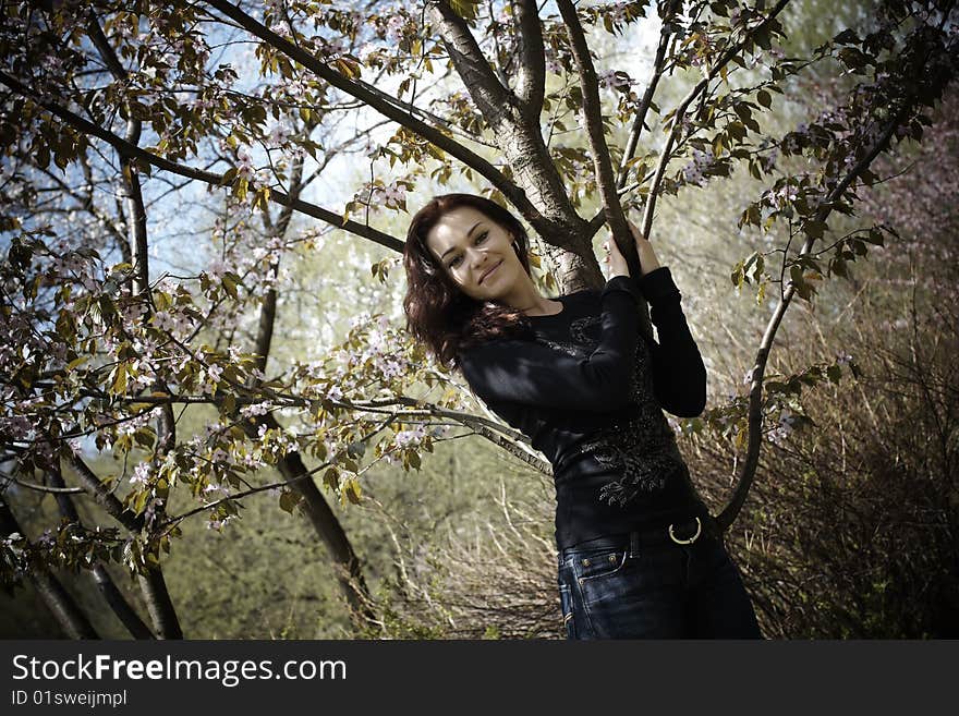 а girl staing near cherry tree. а girl staing near cherry tree