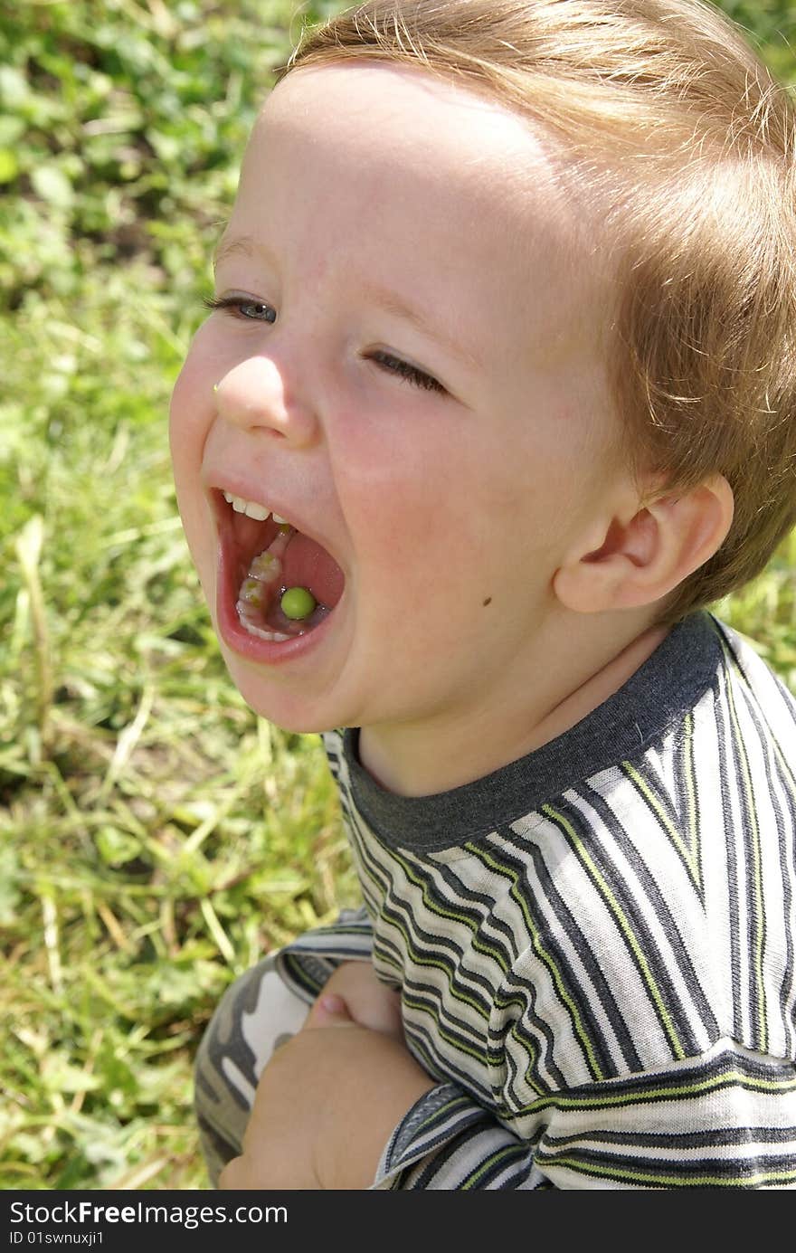 Boy with a pea in the mouth