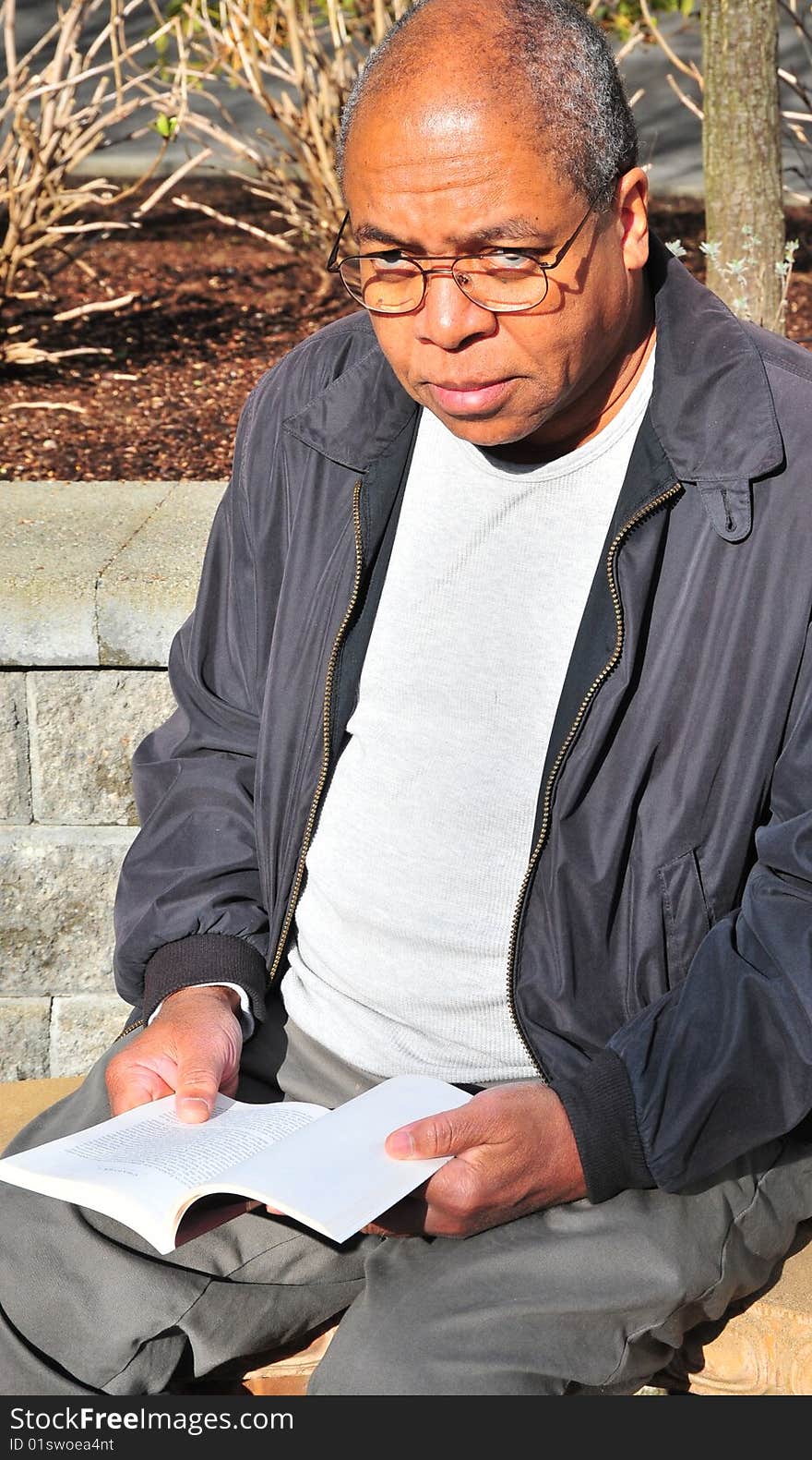 African american male college student studying on a school campus.