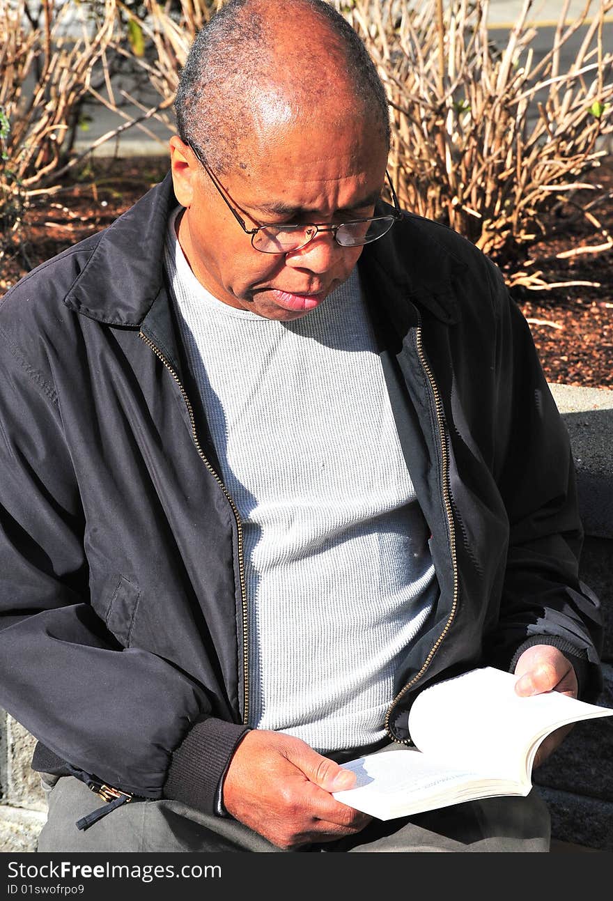 African american male college student studying on a school campus.