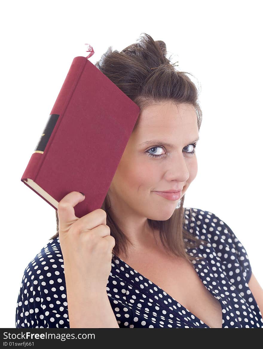 Young woman in dress holding a book to her head; isolated on a white background. Young woman in dress holding a book to her head; isolated on a white background.