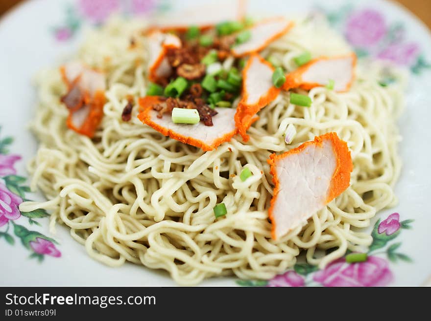 Closeup of Kampua mee (Sarawak Chinese noodles) with roasted pork meat.