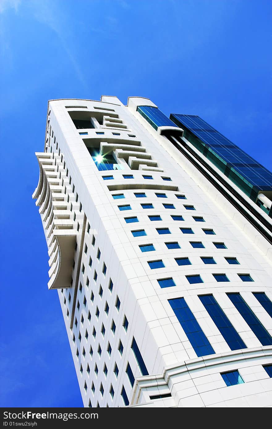 Perspective view of a blue glass skyscraper over blue sky. Perspective view of a blue glass skyscraper over blue sky.