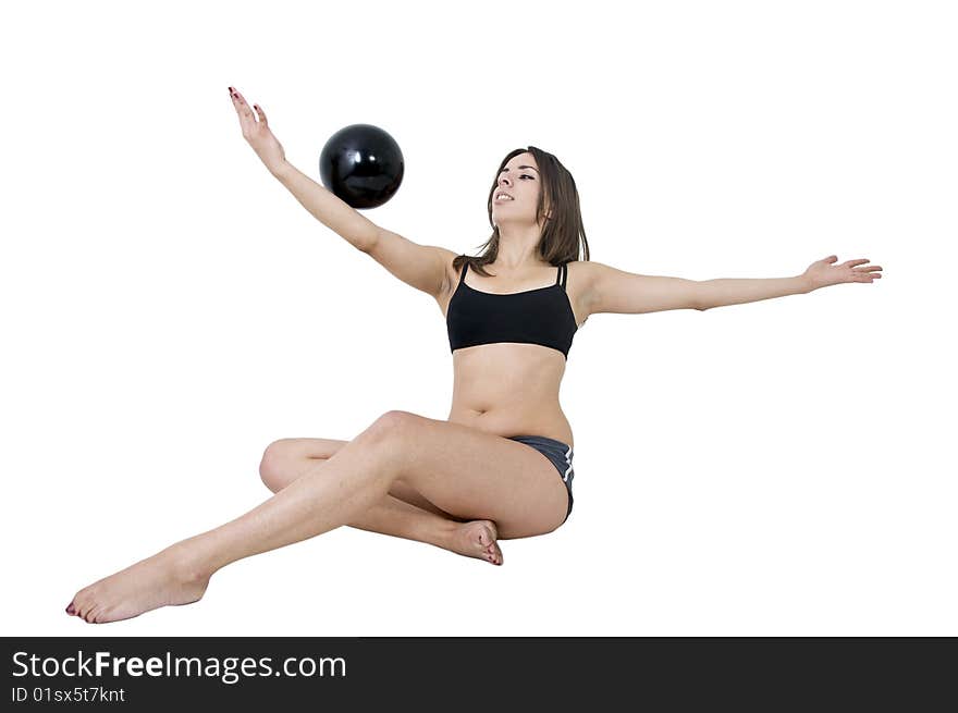 Young girl balancing with black ball