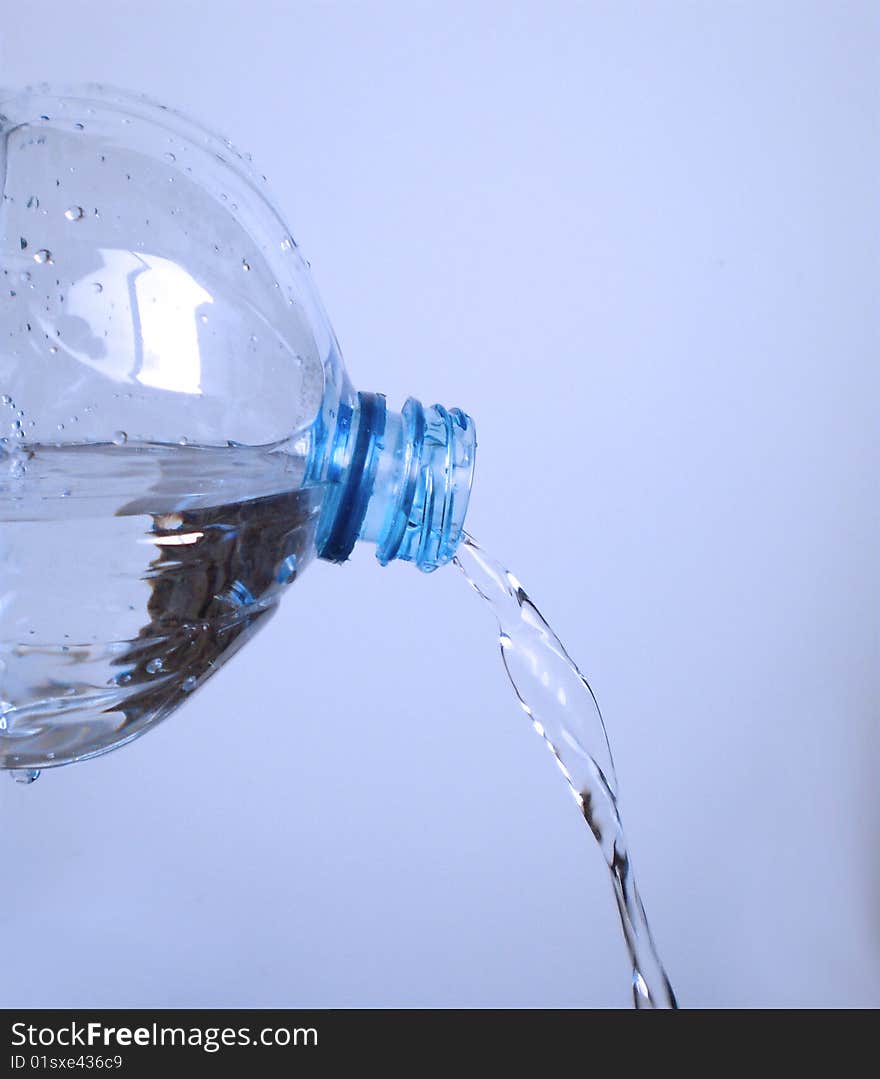 Close up view of Water going out of a plastic bottle. Close up view of Water going out of a plastic bottle