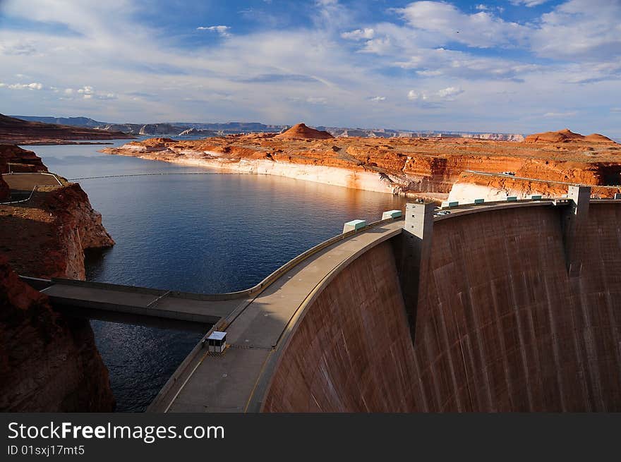 A picturesque view of the curving wall of the Glen Canyon Dam on the Colorado river in Arizona, USA. A picturesque view of the curving wall of the Glen Canyon Dam on the Colorado river in Arizona, USA.