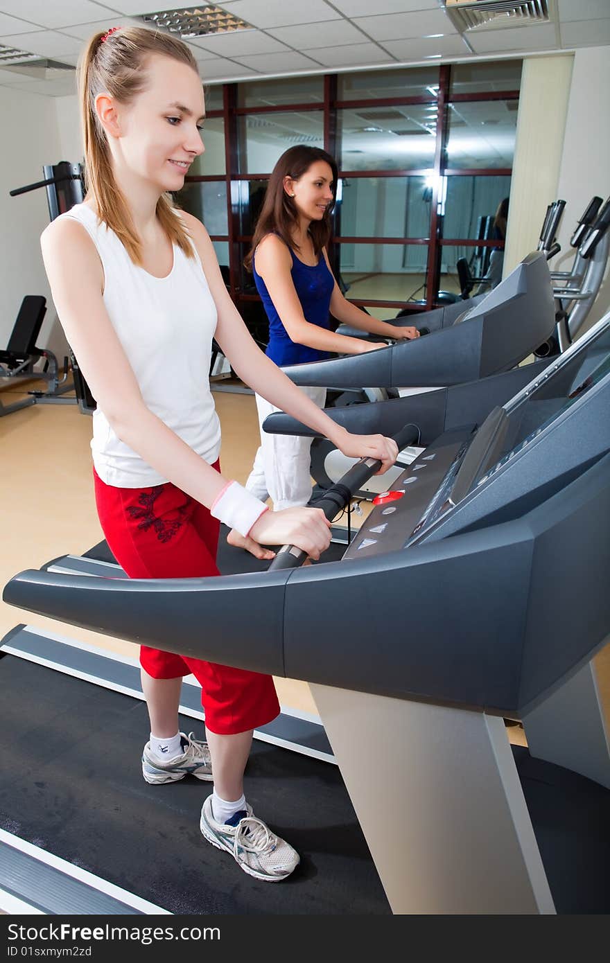 Beautiful girls are engaged in sports hall. Beautiful girls are engaged in sports hall