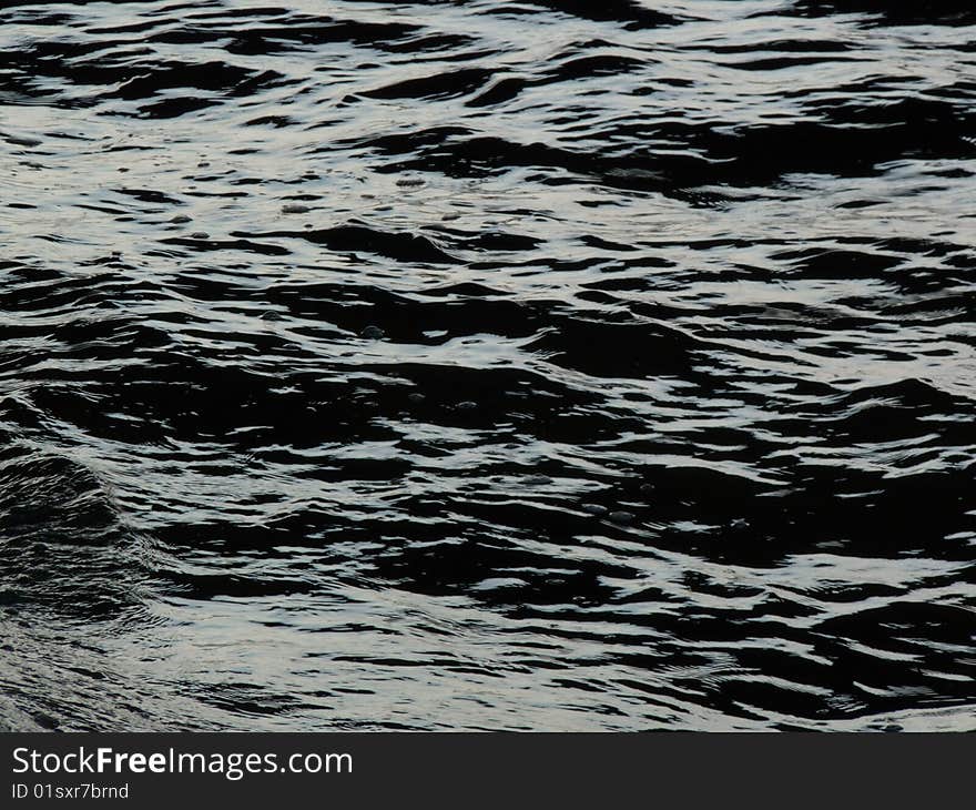 Overexposed surface of water near the bank of the river. It may be interpreted in many ways. Overexposed surface of water near the bank of the river. It may be interpreted in many ways.