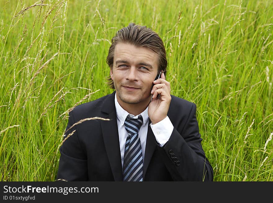 Well-dressed young businessmann is on the phone