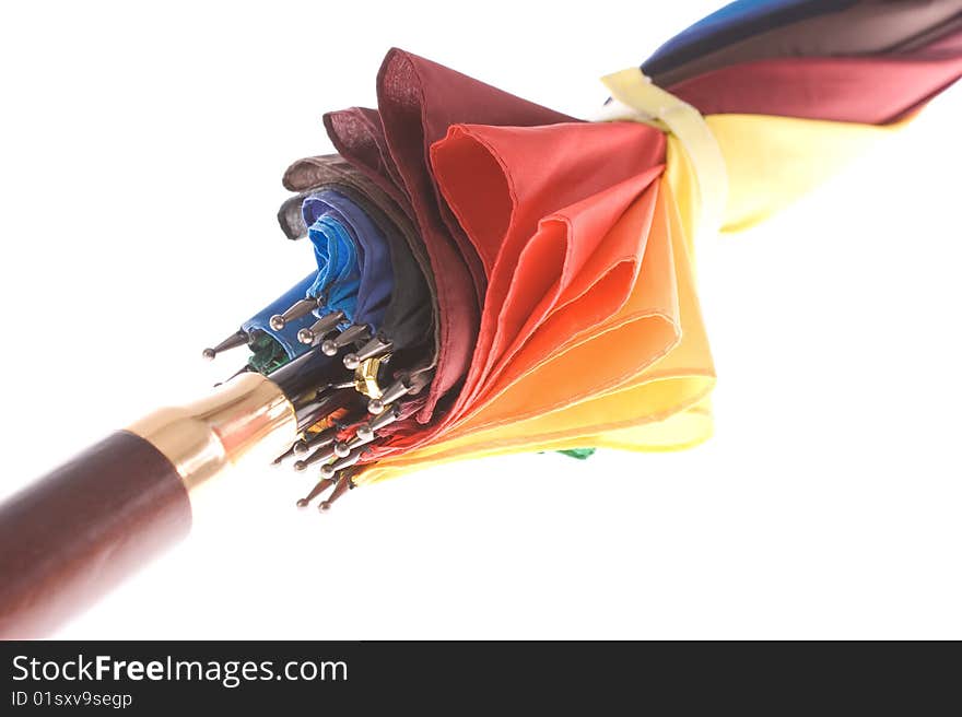 Rainbow colored umbrella on white background