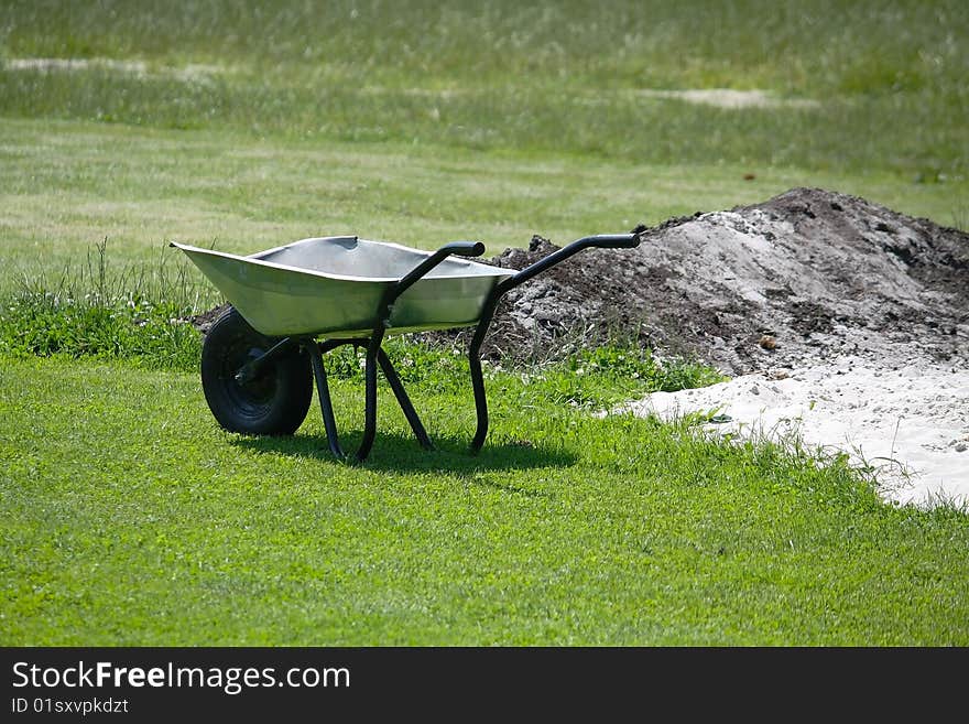 The wheelbarrow on the grass