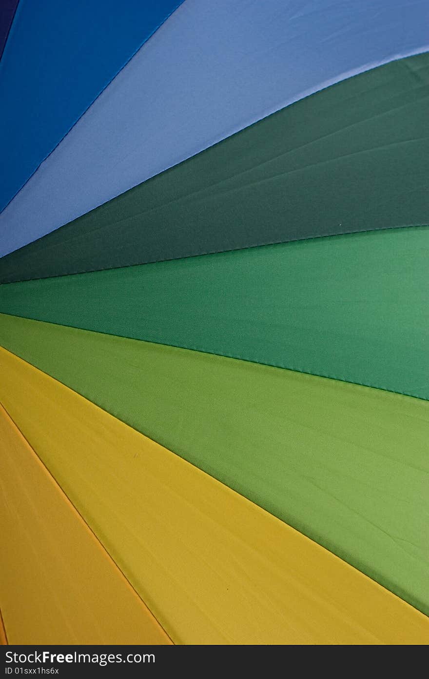 Close up to rainbow colored umbrella useful as background or texture