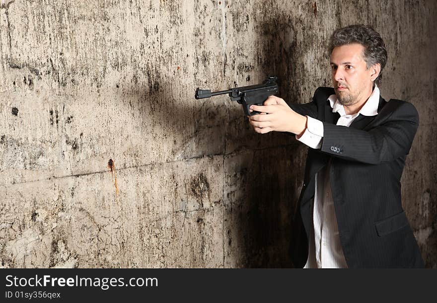 Man killer with gun on dark background. Man killer with gun on dark background