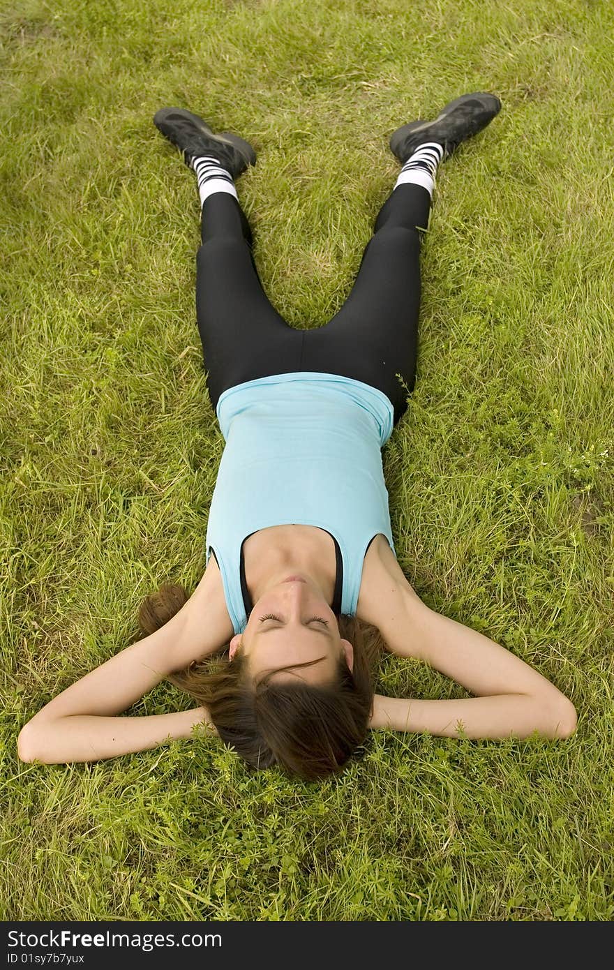 Woman Relaxing On Grass