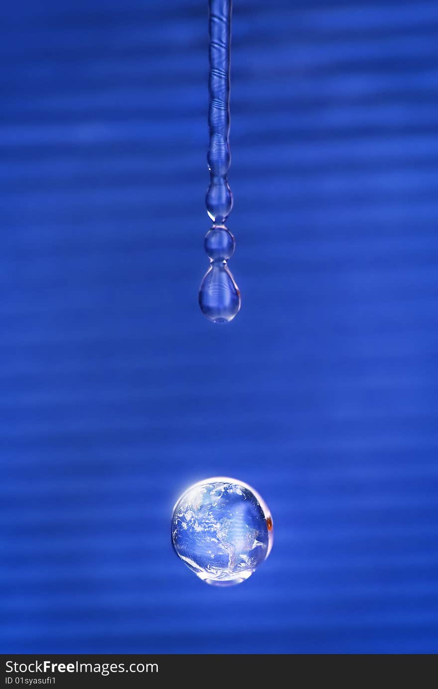 Shining water drop reflecting our planet. Shining water drop reflecting our planet