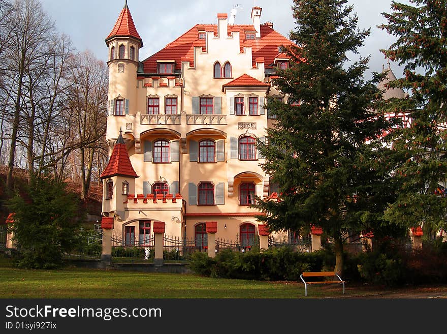 Beautiful building with a red tile roof and towers. City of Karlovy Vary, Czechia. Beautiful building with a red tile roof and towers. City of Karlovy Vary, Czechia.