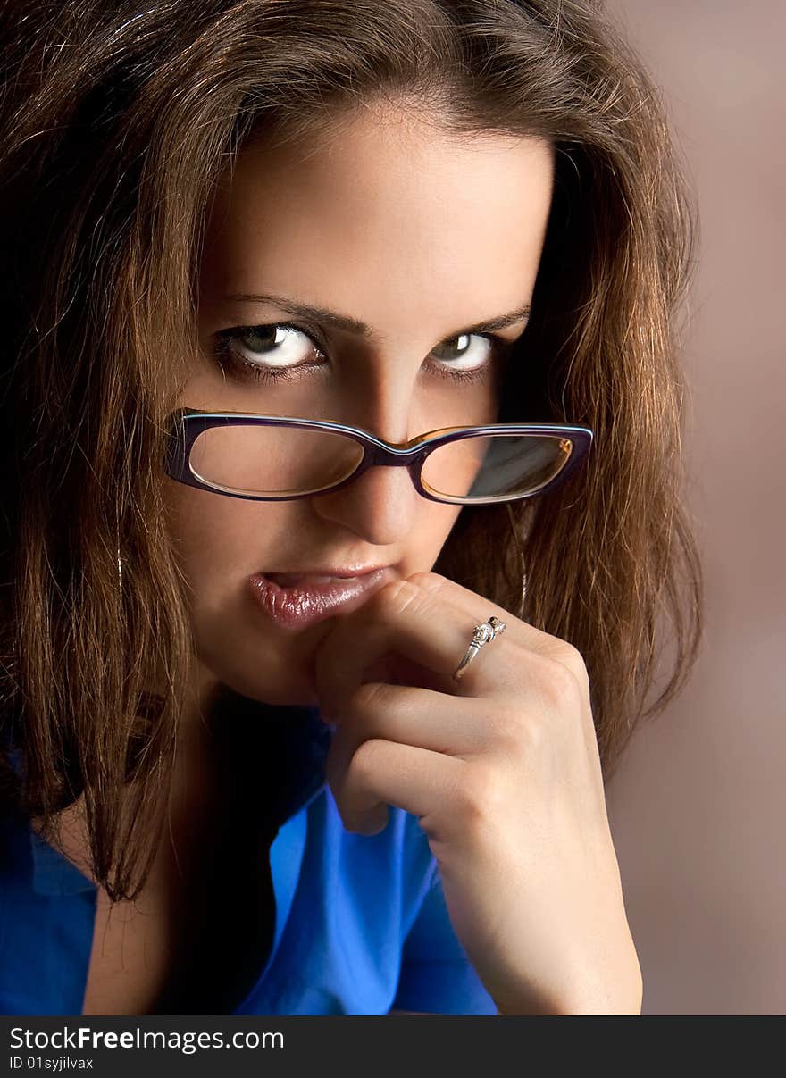 Young beautiful teacher wearing glasses. Studio shot