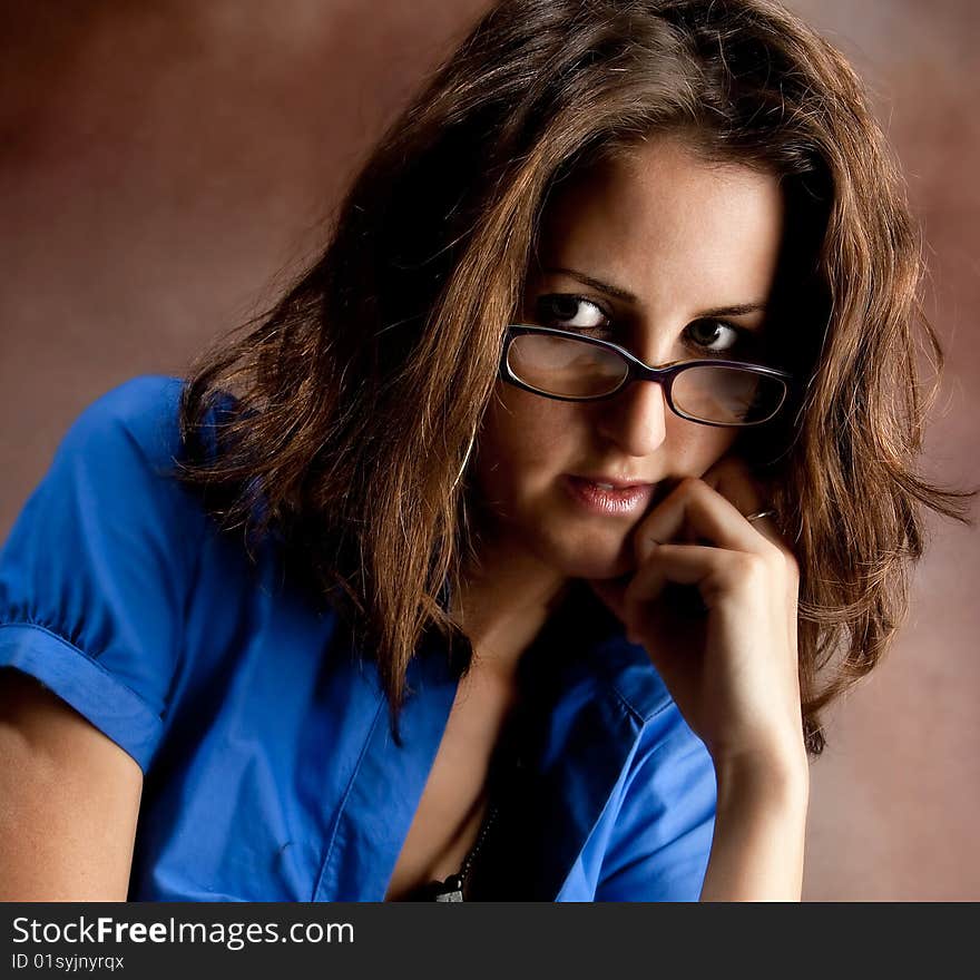 Young beautiful teacher wearing glasses. Studio shot