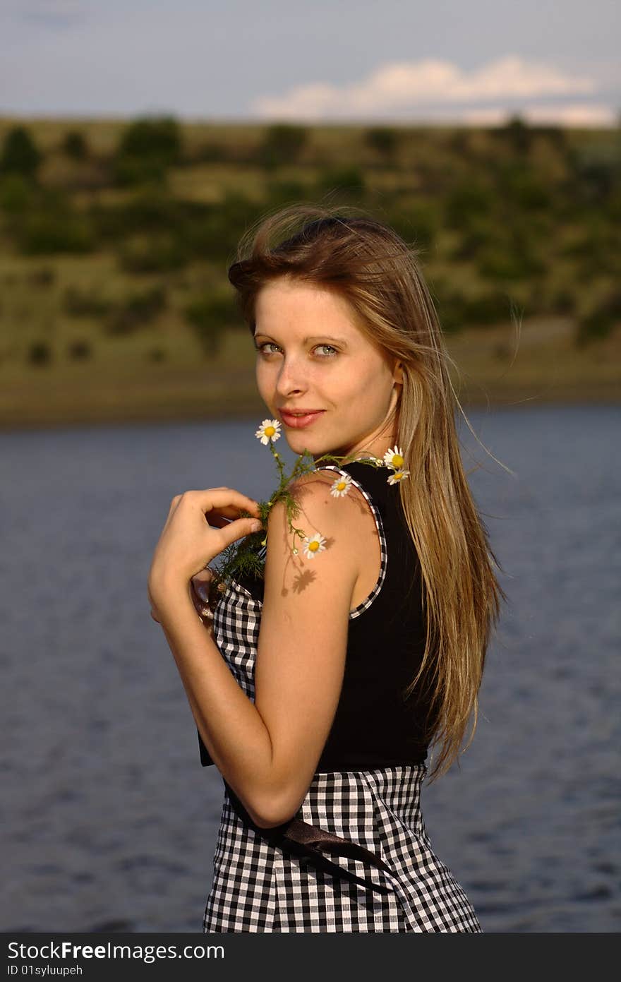 Nice Girl On The Lake Coast With Camomiles