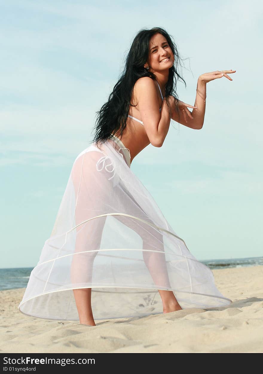 Beautiful girl standing on the beach. Beautiful girl standing on the beach