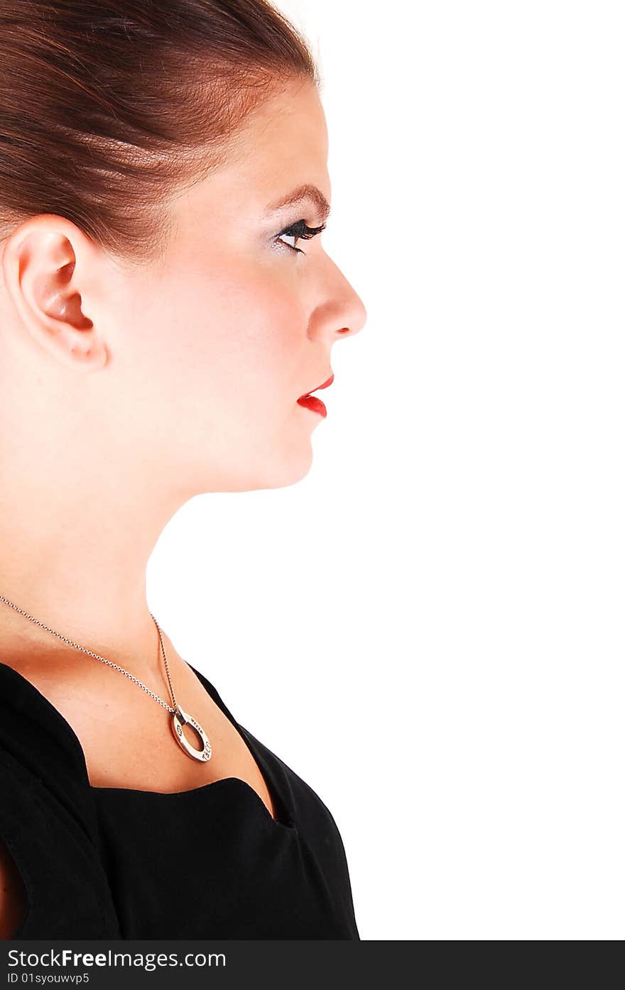 Young light red haired woman in an black dress standing in the studio 
for white background, in profile. Young light red haired woman in an black dress standing in the studio 
for white background, in profile.