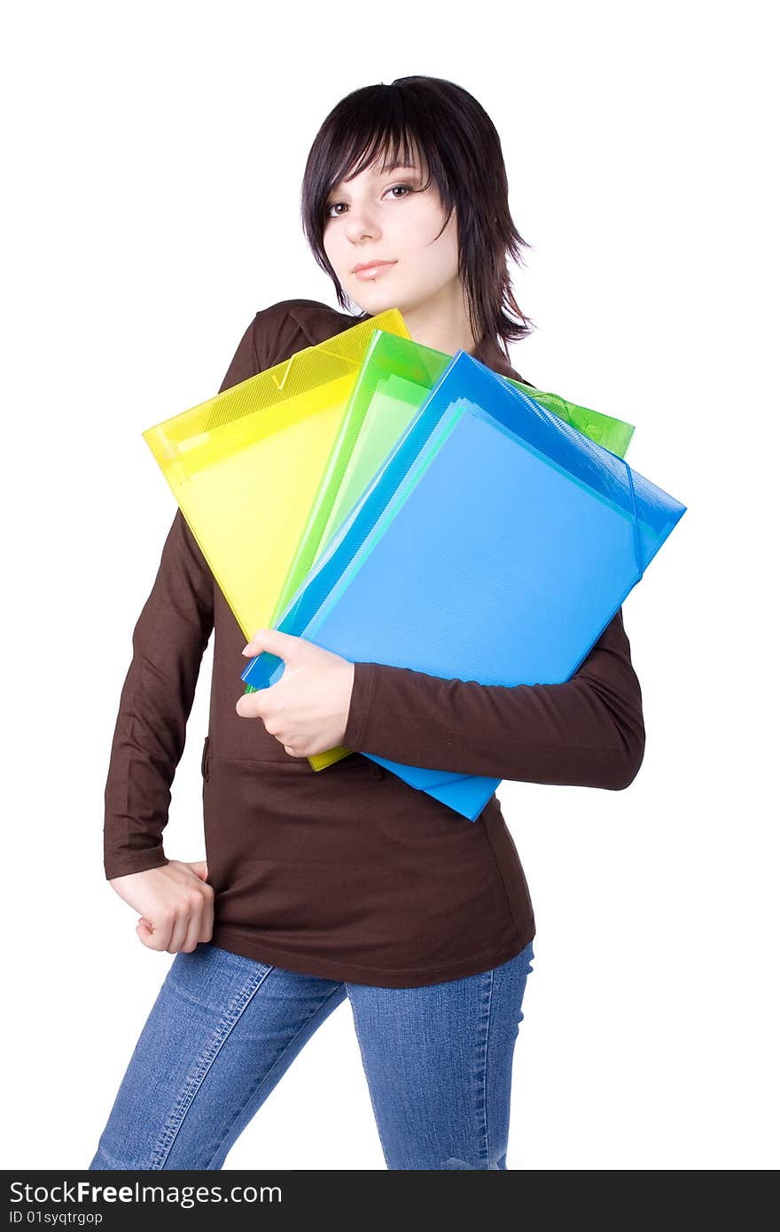 The young beautiful businesswoman at office behind work on a white background. The young beautiful businesswoman at office behind work on a white background