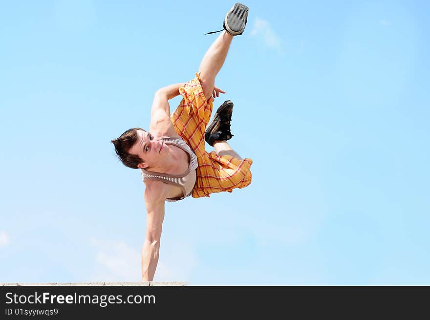 Man dances a break-dans against the sky. Man dances a break-dans against the sky