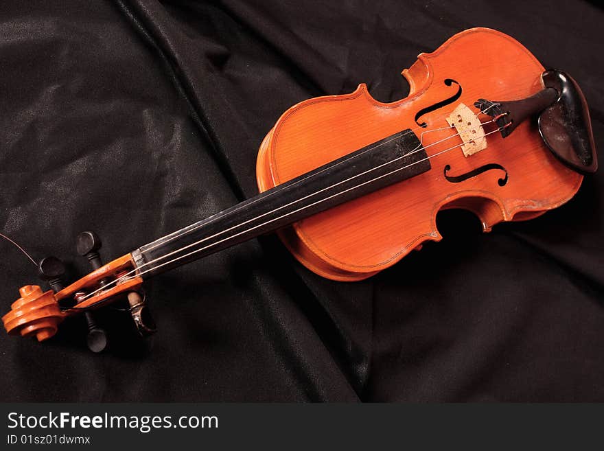 Old violin on the black background