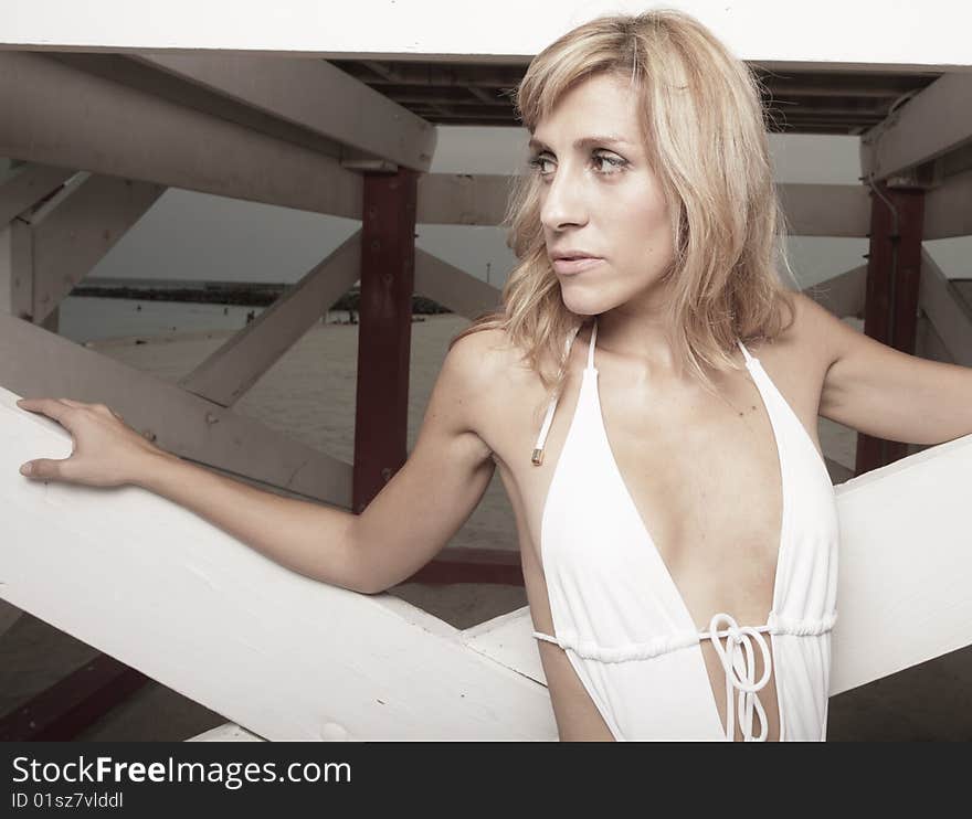 Woman posing by a lifeguard hut