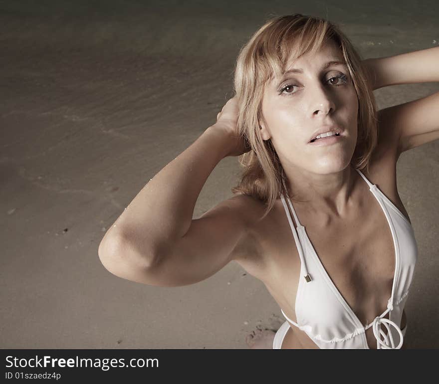 Woman posing by the shore