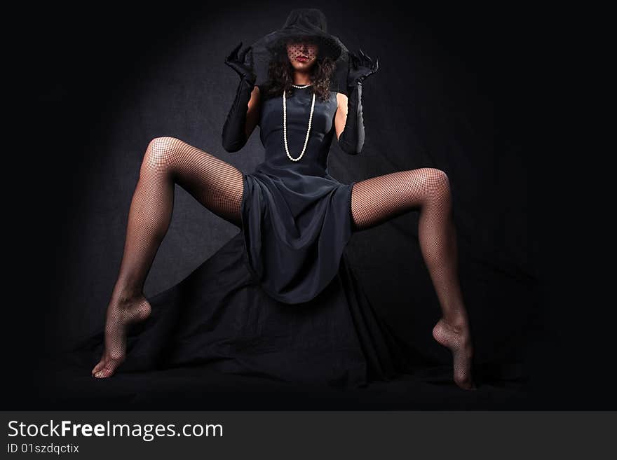 Girl with long legs against black background