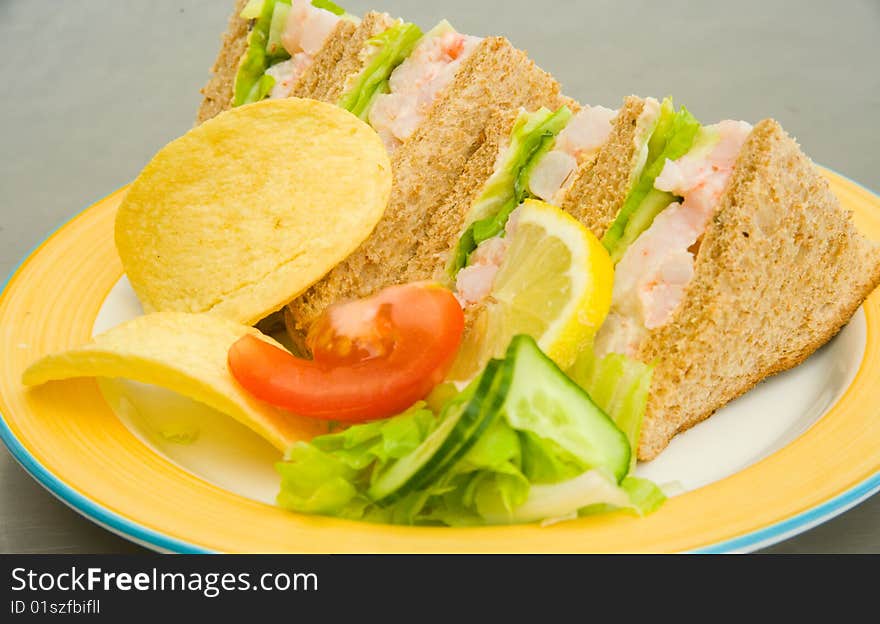 Prawn sandwich with a slice of lemon, tomato, cucumber and  lettuce. Prawn sandwich with a slice of lemon, tomato, cucumber and  lettuce.