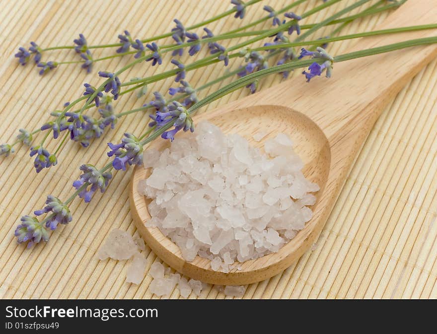 Sea saltin in a wooden spoon and lavender. Sea saltin in a wooden spoon and lavender