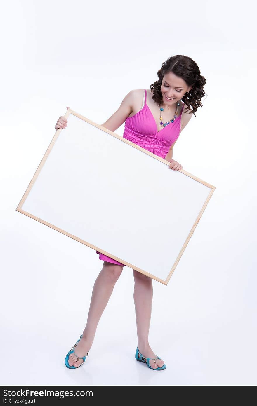 Young attractive woman holding white board surprising. Young attractive woman holding white board surprising