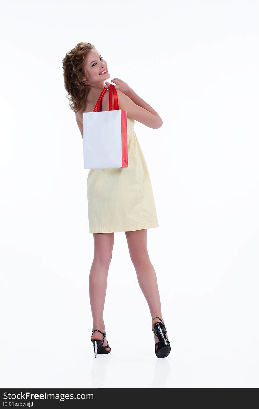 Young woman with shopping bag looking back and laughing. Young woman with shopping bag looking back and laughing