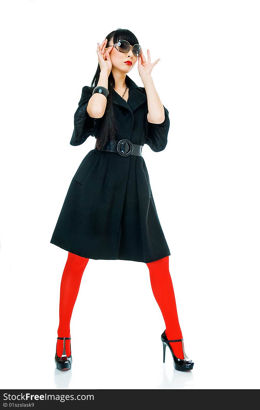 Charming model in black light overcoat, sun glasses and red tights