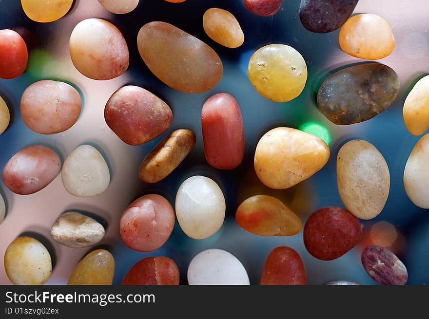 Colorful stones background, shot from directly above parallel.