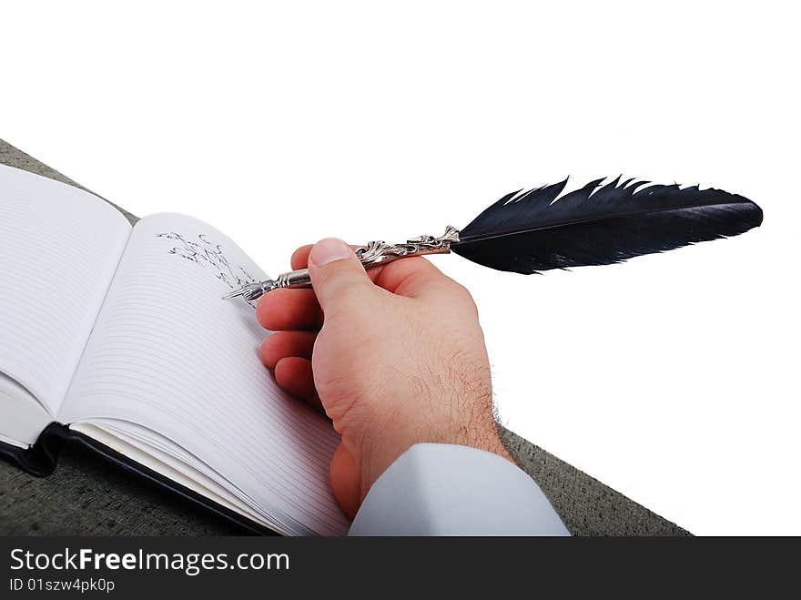 Male hand is writting on paper by the feather. Male hand is writting on paper by the feather