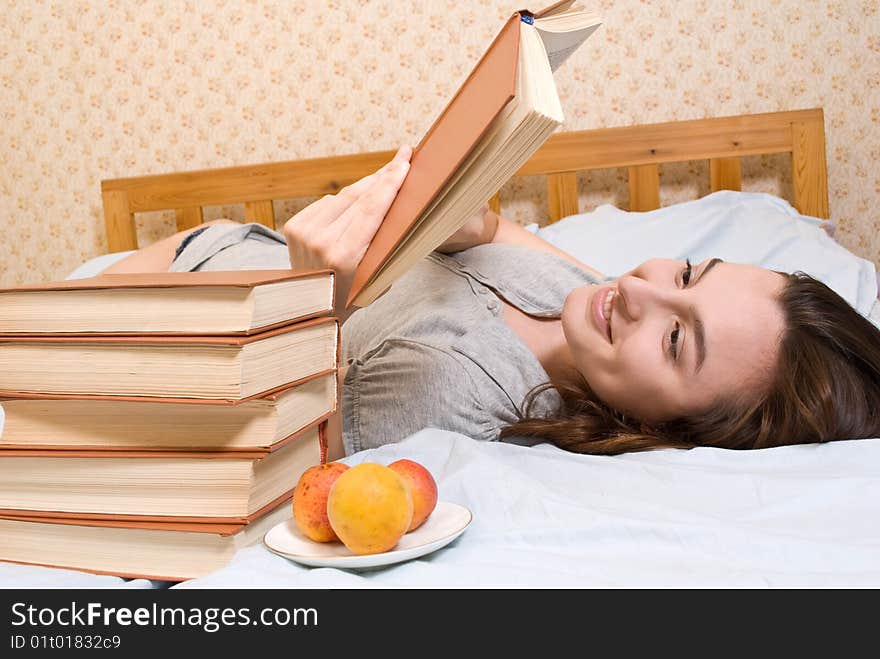 Young smiling student woman reads a book. Young smiling student woman reads a book