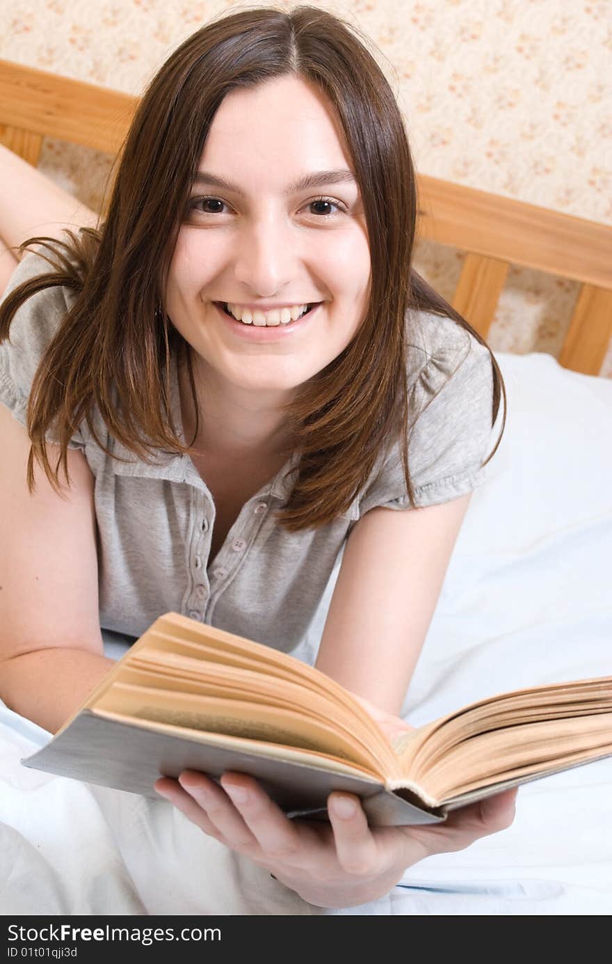 Young smiling student woman reads a book. Young smiling student woman reads a book