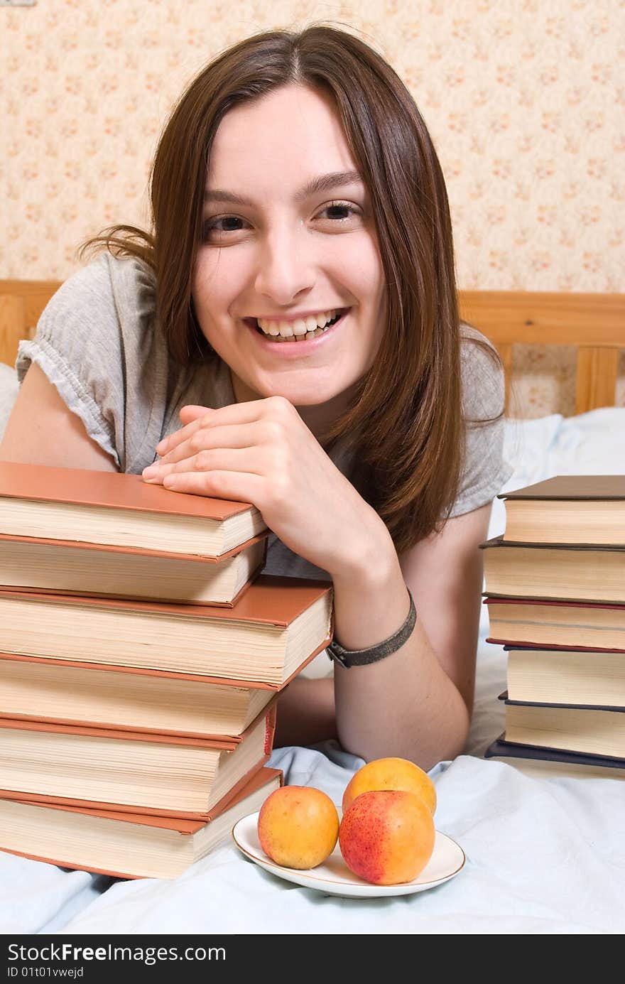 Young smiling student woman with books